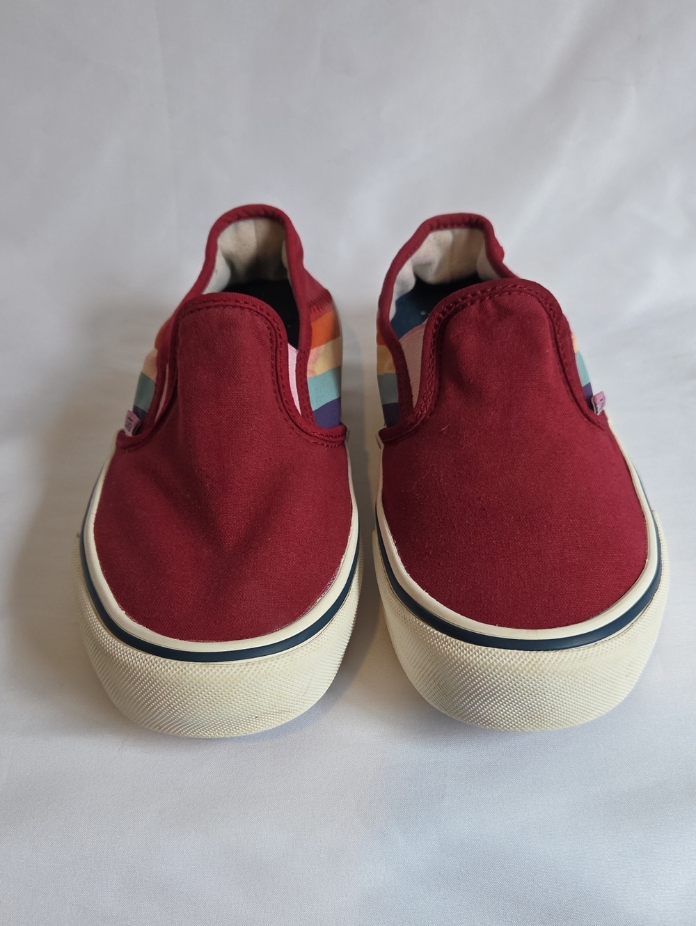 Vans Slip-On Sneakers in Burgundy with Rainbow Side Stripes